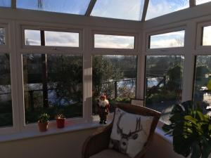 a person standing in a room with windows at Sealladh Sona in Inverness