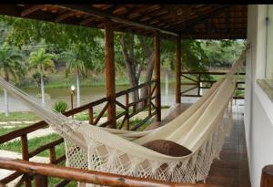 a hammock on the porch of a house at Raposo Vale Encantado Pousada in Antônio Prado