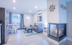 a living room with a fireplace and a couch at Boutique Suite #2 in Blue Mountains