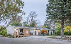 a home in the woods with a tree at Boutique Suite #2 in Blue Mountains