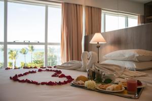 a hotel room with a tray of food on a bed at Hotel Beira Mar in Fortaleza