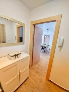a bathroom with a sink and a mirror and a table at Tusculum apartment Solin in Solin