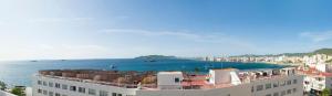 a view of a city with the ocean and buildings at Hostal Costa Blanca in Ibiza Town