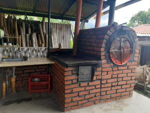 a brick oven with a clock on the side of it at Martyni Campestre in Garzón