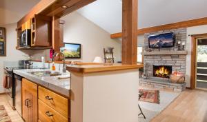 a kitchen with a fireplace in the middle of a room at Tamarack in Wilson