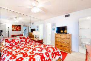 a bedroom with a red and white bed and a mirror at Sea Colony - 908 Dover House Rd in Bethany Beach +40 photos