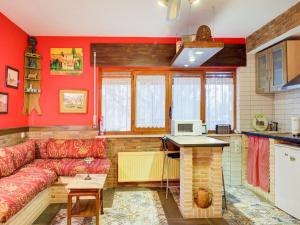 a living room with a couch and a kitchen at Rural apartment with shared garden pool and Spa in Galapagar