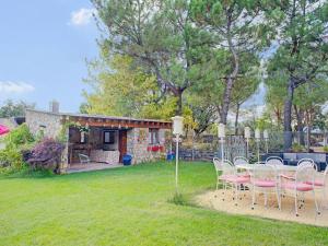 a table and chairs in a yard with a house at Rural apartment with shared garden pool and Spa in Galapagar