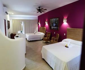 Postel nebo postele na pokoji v ubytování Hotelito Los Sueños + 37 fotografií