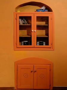 a cabinet with ajar doors in a wall at Casa Odette Calcata in Calcata
