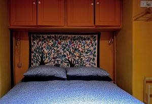 a bedroom with a bed with a head board at Casa Odette Calcata in Calcata