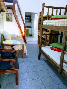 a room with several bunk beds and a staircase at Solar Dona Maria in Pinheiro