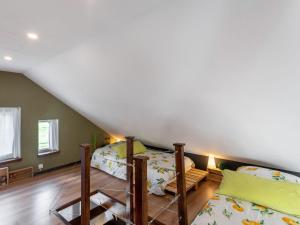 a bedroom with two bunk beds in a attic at Stylish Stay in Birresborn in Birresborn