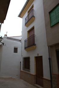 a white building with two balconies on the side of it at Casa Arminda in Benafer