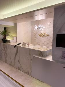 a hotel lobby with a marble counter and a television at Hotel Venus Garden(Adult Only) in Nagoya