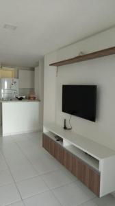 a living room with a flat screen tv on a wall at Varandas do Francês in Maceió