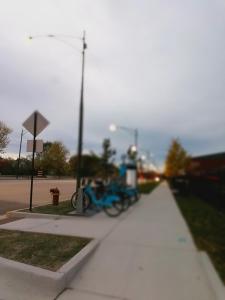 a blue bike is parked on a sidewalk at 5430 Happy Home in Chicago +5 photos