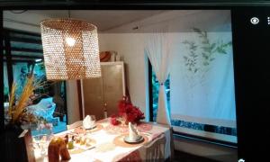 a dining room with a table and a chandelier at Mamy Cherie in Rodrigues Island