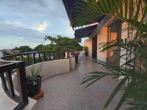 a balcony of a building with plants on it at HOSPEDAJE CARIBE EXPRESS in Cartagena de Indias