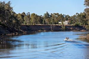 two people on a boat on a river at Discovery Parks - Echuca in Echuca