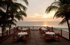 a restaurant on the beach with a view of the ocean at Patra Anyer in Anyer