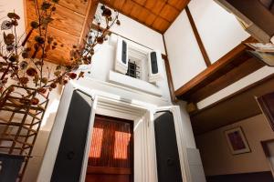 a hallway of a house with the door open at Kadokyu Ryokan in Takaoka