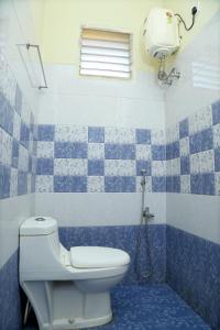 a blue and white bathroom with a toilet and a shower at Lakeview Residency, Sricity TADA in Tada