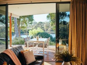 a living room with a table and chairs on a patio at Eight Willows Retreat in Margaret River Town +49 photos