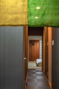 a view of a hallway with a bed in a room at Kamo River J~House in Kyoto