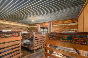 a log cabin with two beds in a room at Dargo Hotel in Dargo
