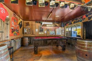 a bar with a pool table in a room with barrels at Dargo Hotel in Dargo