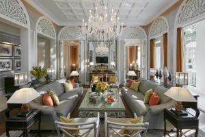 a living room with a couch and a chandelier at Mandarin Oriental Bangkok - SHA Extra Plus in Bangkok