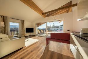 a kitchen and living room with a large window at berg und tal - schlosserhaus 31 in Tesimo