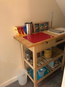a table with a red cutting board on top of it at M60 Modern Studio Appartment with free parking in Denton