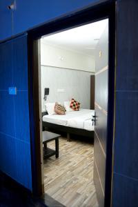 a view of a bedroom with a bed and a mirror at Lakeview Residency, Sricity TADA in Tada