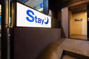 a sign for a stay sign in a building at Stay Hakata in Fukuoka +77 photos