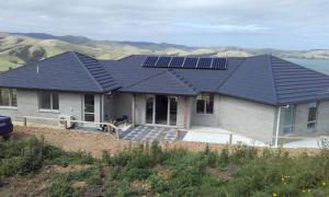 a house with solar panels on the roof at Niagara Ridge Retreat Catlins in Niagara
