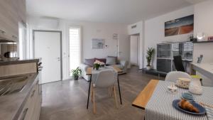 a kitchen and living room with a table and chairs at Maisonette Modena Park in Modena