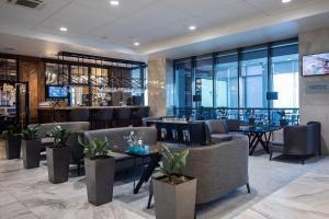 a lobby with couches and tables and a bar at Mirotel Novosibirsk in Novosibirsk