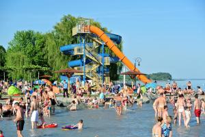 a large crowd of people at a beach at Aart Apartman in Csopak