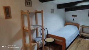 a bedroom with a bunk bed and a shelf at Gîte de La Tour in Saint-Guilhem-le-Désert