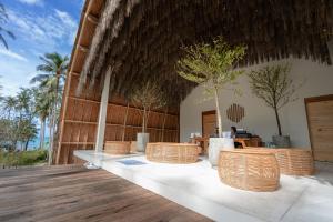 a restaurant with wicker chairs on a wooden deck at Hideout Koh Kood in Ko Kood +125 photos