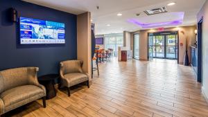 a lobby with chairs and a large screen on the wall at Best Western Inn Florence in Florence