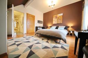 a bedroom with a bed and a rug on the floor at B&B Corseaux Beach & Riviera Beach in Vevey