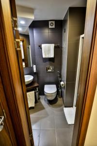 a bathroom with a toilet and a sink at Boutique Hotel Golden Star in Tuzla