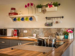 a kitchen counter with pots and pans on the wall at Chateau Le Retail in Saint-Hilaire-des-Loges
