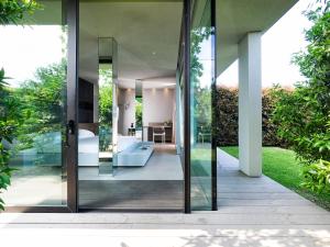 a glass extension to a house with a garden at Zash Country Boutique hotel & SPA in Giarre