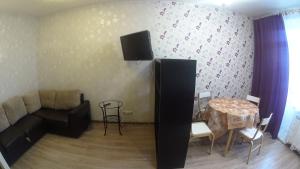 a living room with a couch and a table at Апартаменты на Челюскинцев 3 in Novosibirsk