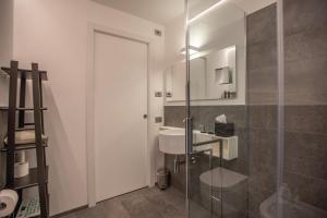 a bathroom with a sink and a glass shower at L'Atelier du Temps - Maison Maillet in Aosta +32 photos