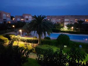 a view of a swimming pool at night at LES SOLEILLADES Parking 200 mètres plage in Marsillargues
